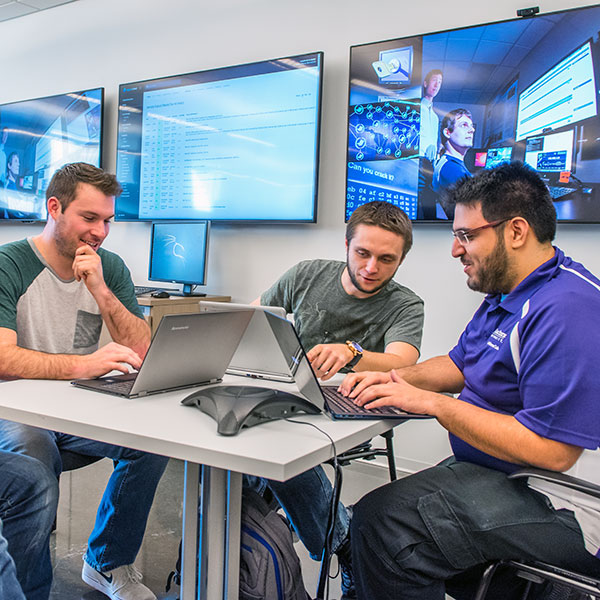 Three students working together on a project